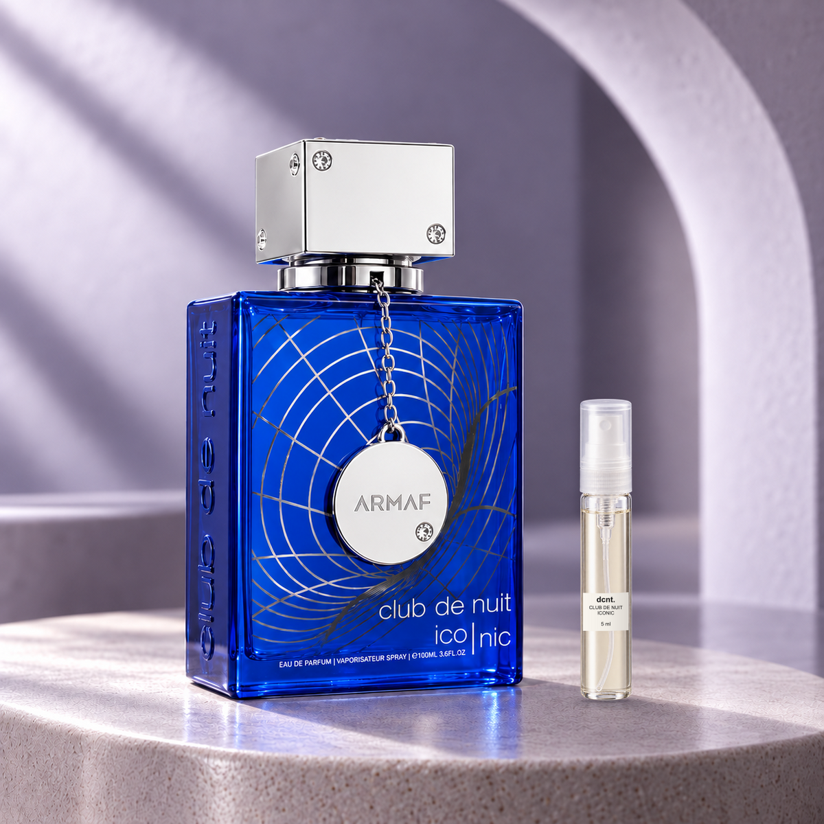 Club de Nuit Iconic original perfume bottle beside a filled 5 ml dcnt.ph glass decant