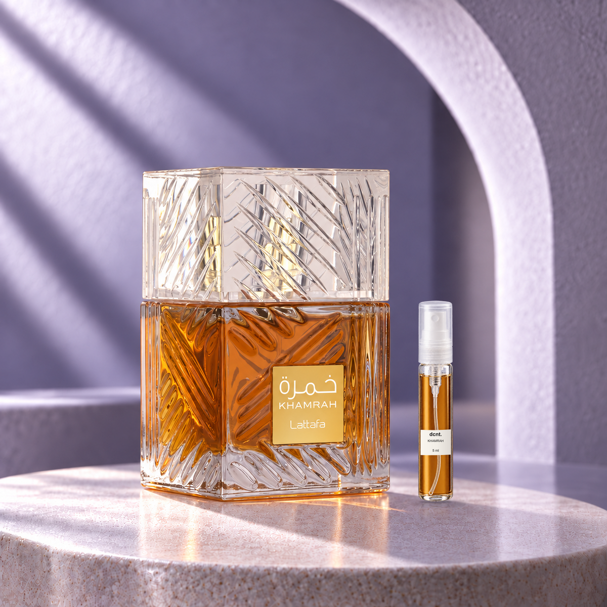 Khamrah original perfume bottle beside a filled 5 ml dcnt.ph glass decant